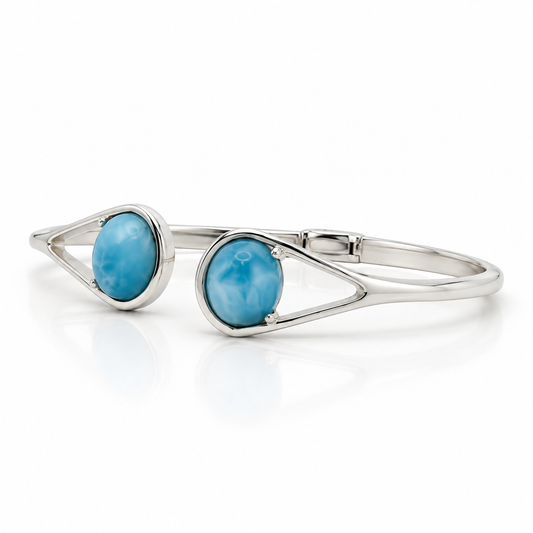 Two-stone Larimar sterling silver bypass cuff bracelet, right angled view on glossy white