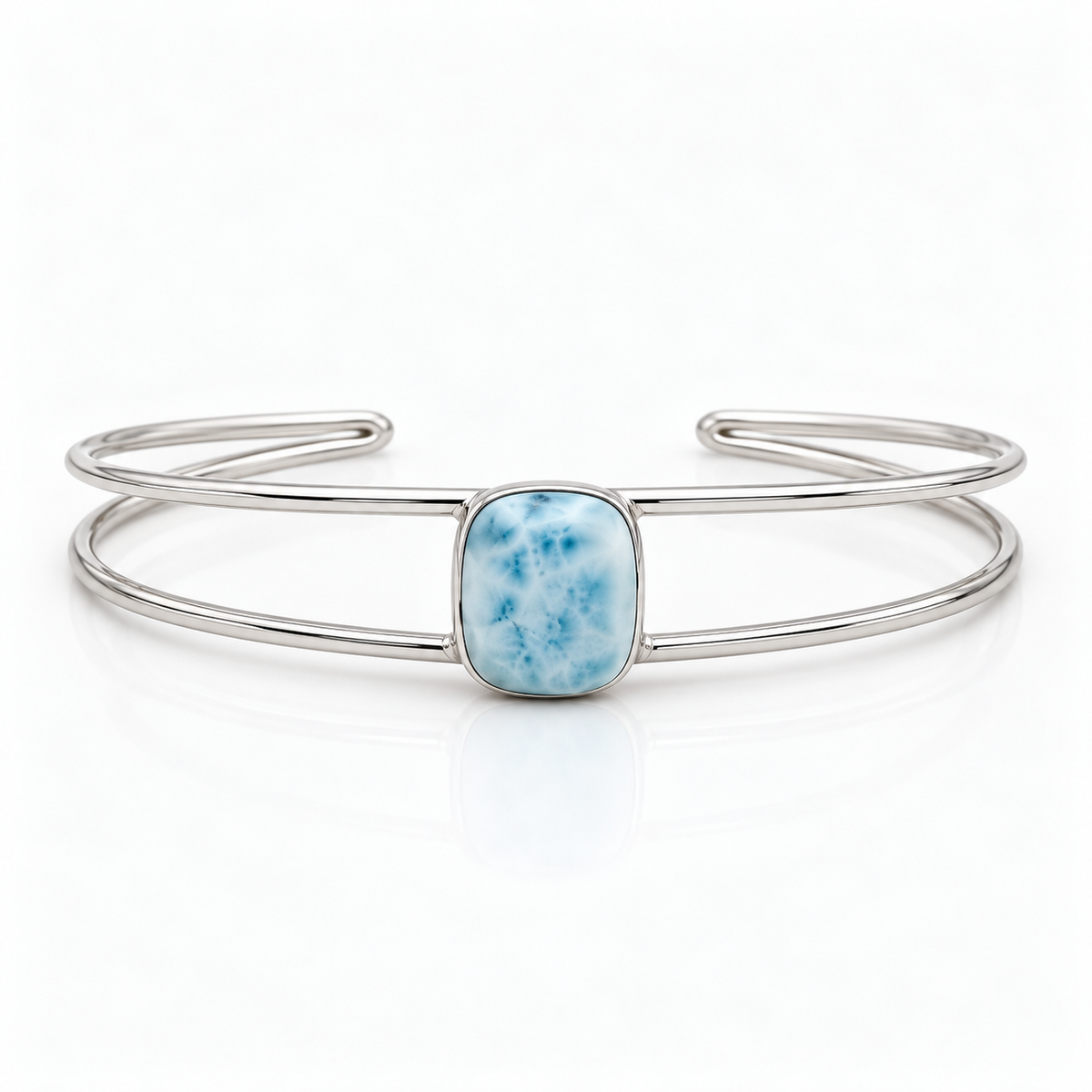Cushion-shaped Larimar sterling silver double-wire cuff bracelet, centered front view on glossy white
