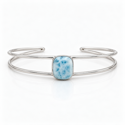 Cushion-shaped Larimar sterling silver double-wire cuff bracelet, centered front view on glossy white