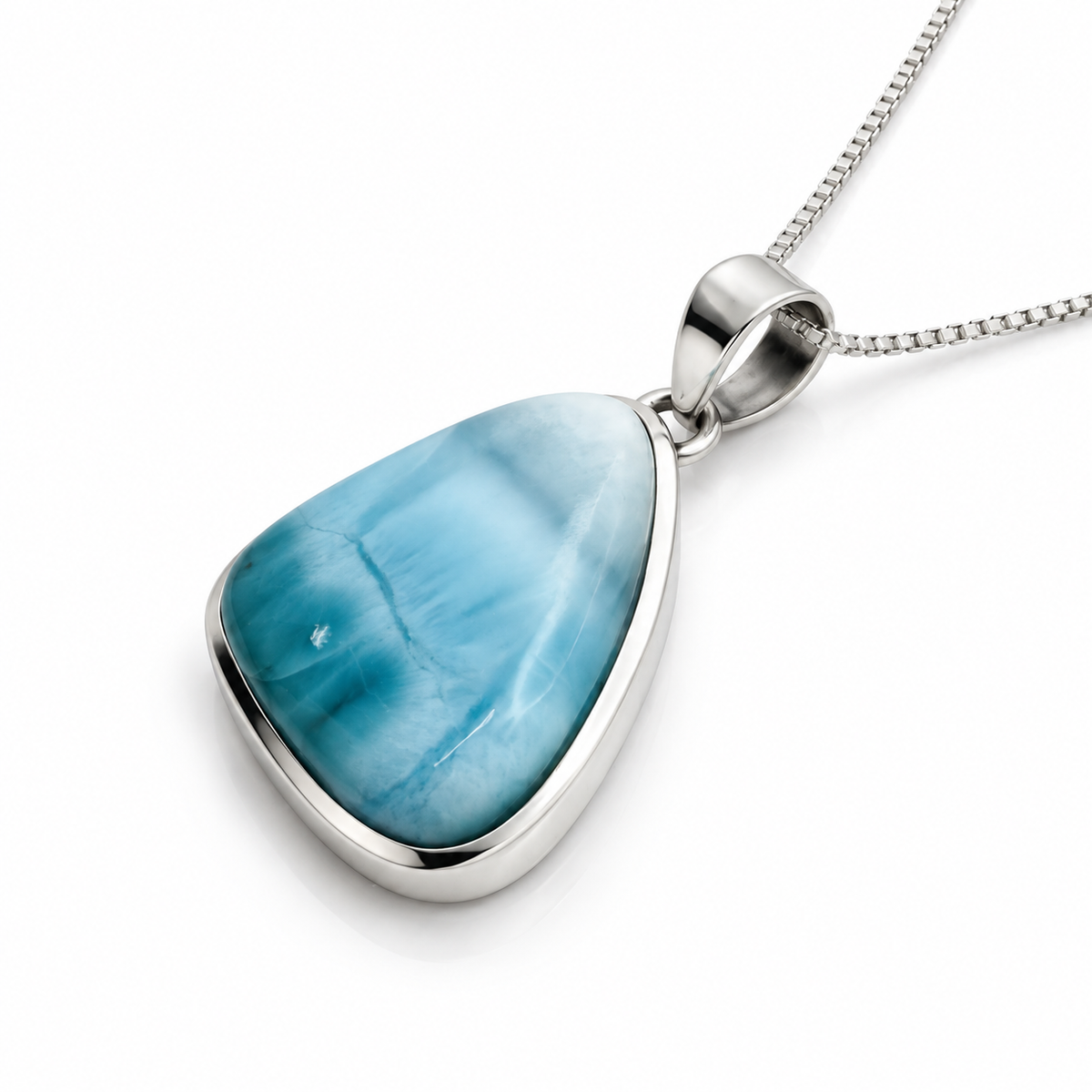 Deep aqua teardrop Larimar necklace in sterling silver, angled view on glossy white
