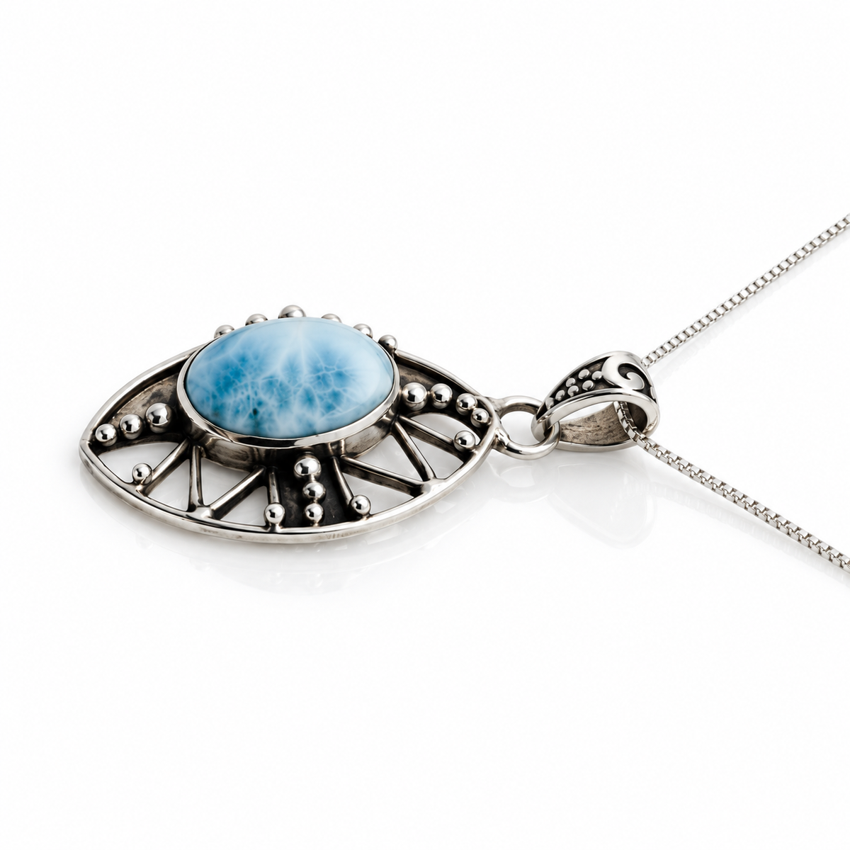 Larimar filigree necklace with silver bead details and engraved bail, angled view