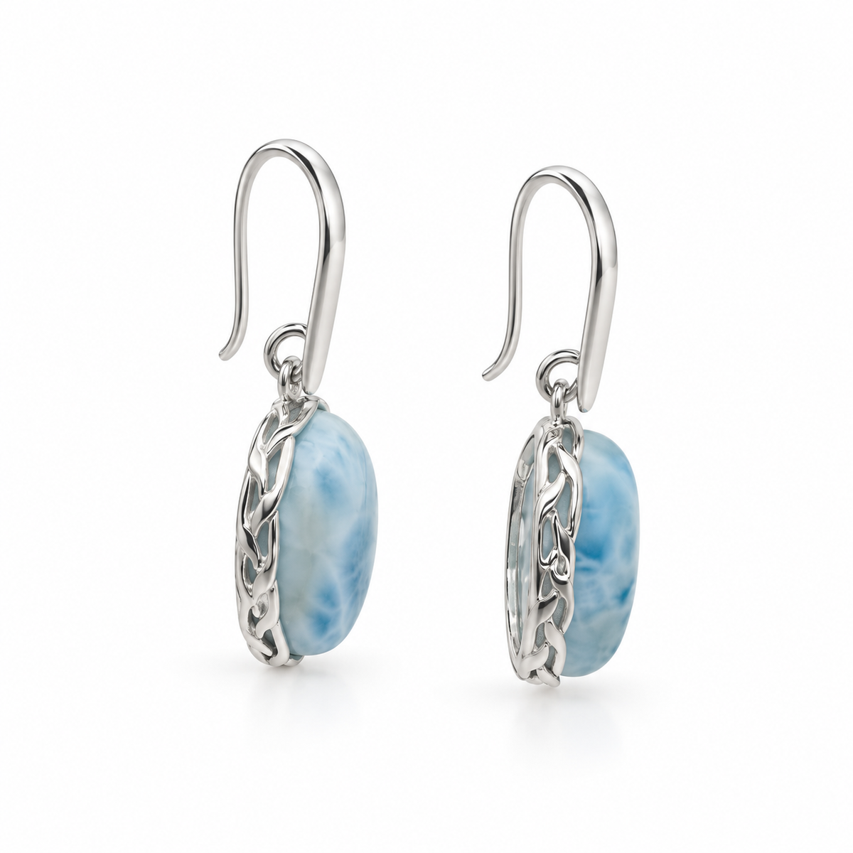 Side view of oval Larimar earrings showing textured silver settings and tapered earwires on white.