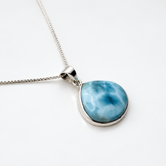 Larimar Blue Nebula necklace, angled view on glossy white