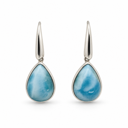 Front view of pear-shaped Larimar earrings with plain silver bezels and tapered earwires on white.