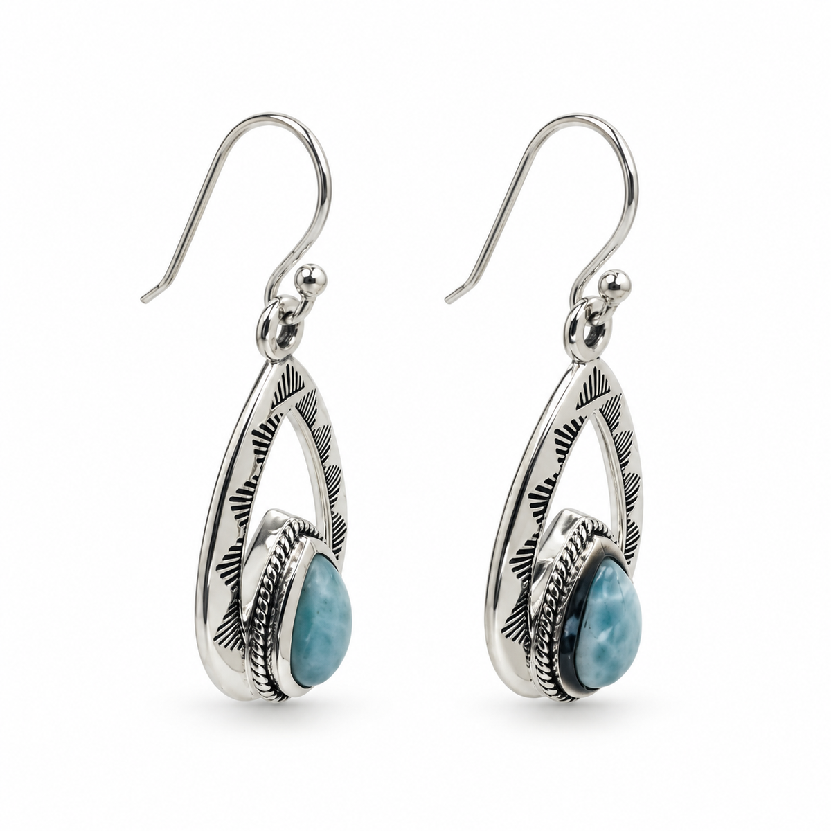 Angled view of Larimar teardrop earrings showing engraved silver frames and rope-trimmed settings.