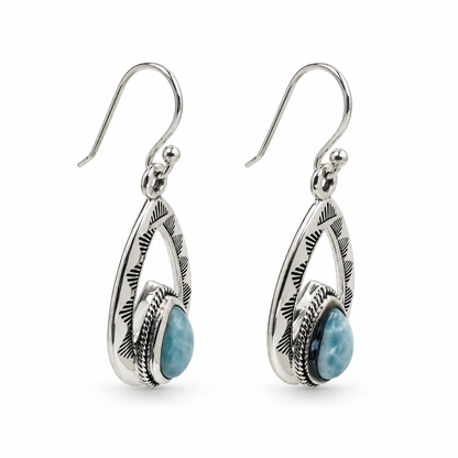 Angled view of Larimar teardrop earrings showing engraved silver frames and rope-trimmed settings.