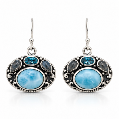 Ornate oval Larimar earrings with blue and gray accent stones in oxidized sterling silver, front view.