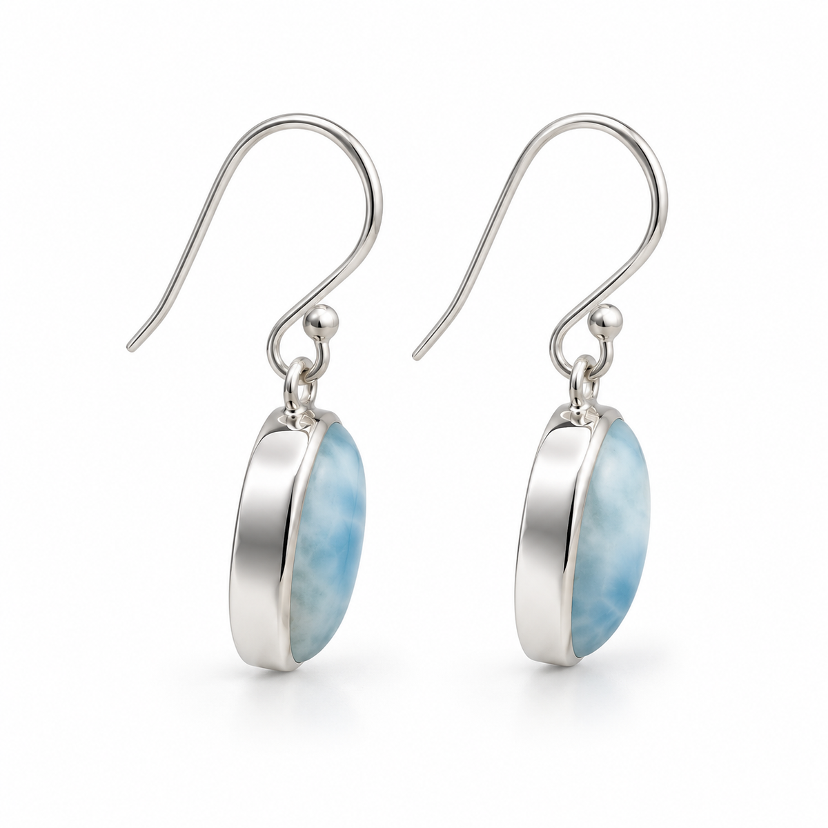 Side view of oval Larimar earrings with polished silver bezel sidewalls and photographer reflections removed.
