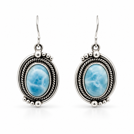 Oval Larimar earrings with rope borders and graduated silver bead accents, front view on white.