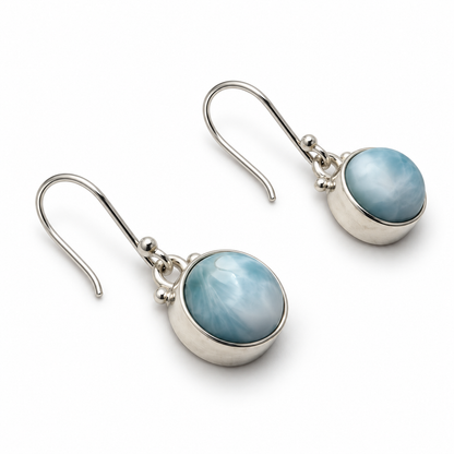 Round Larimar sterling silver drop earrings, left angled view on white.
