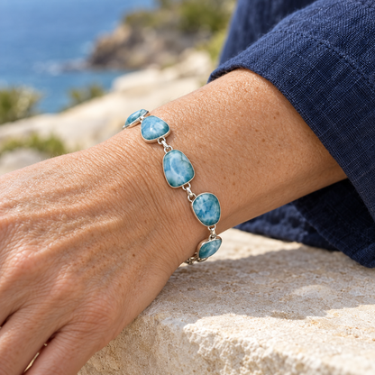 Mature woman wearing adjustable six-stone Larimar sterling silver link bracelet