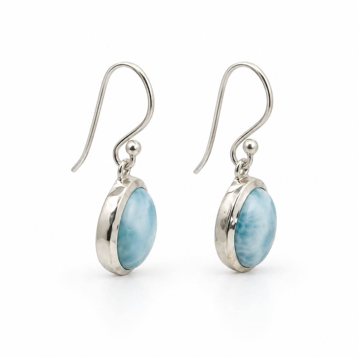 Angled side view of oval Larimar sterling silver earrings with cleaned neutral silver reflections.
