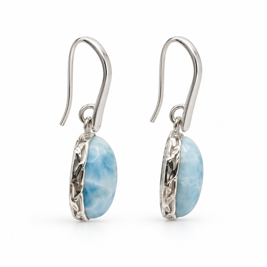 Side view of oval Larimar earrings showing organic textured silver settings and tapered earwires.