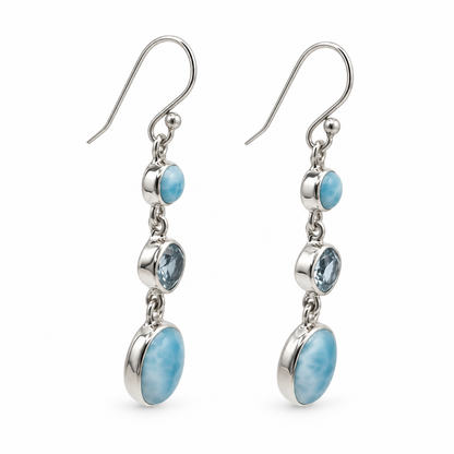 Angled view of three-stone Larimar drop earrings with polished sterling silver bezels.