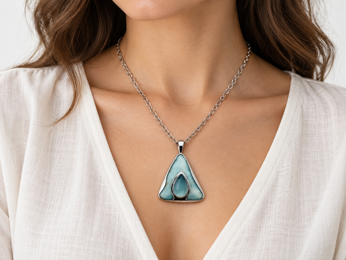 Larimar necklace on model wearing a light V-neck blouse