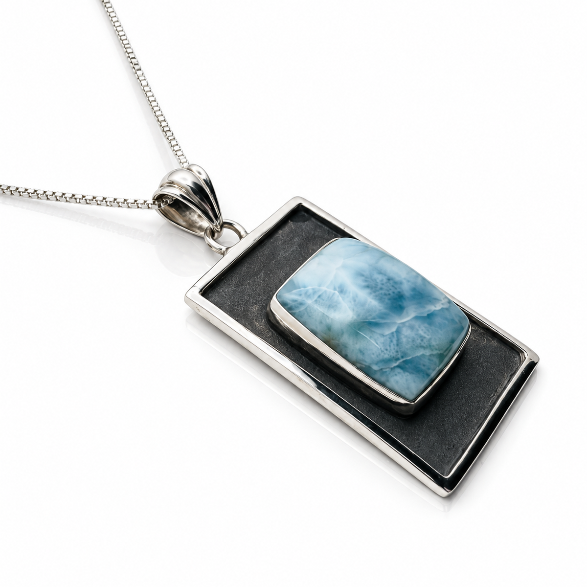 Ocean Tableau Larimar necklace with raised stone and oxidized sterling frame, angled view