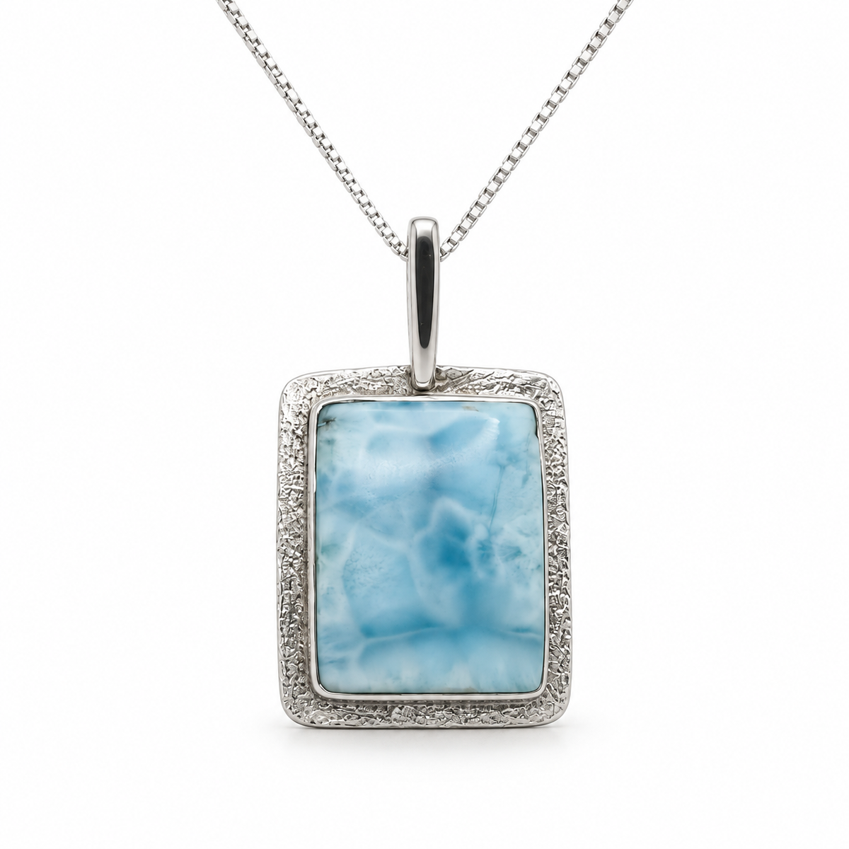 Rectangular Larimar necklace with textured sterling silver frame, front view on glossy white