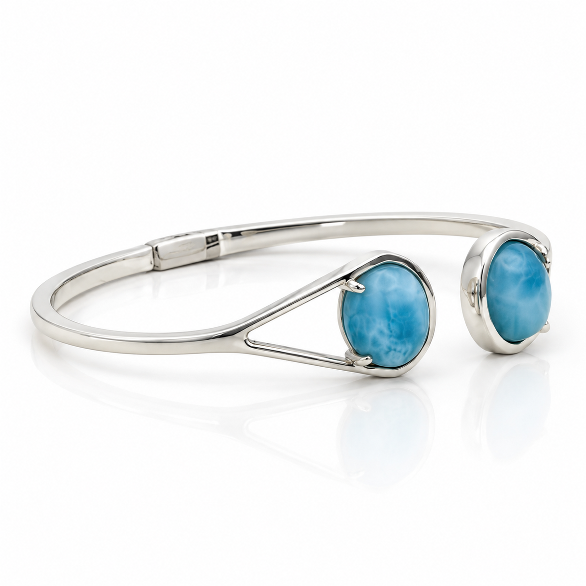 Two-stone Larimar sterling silver bypass cuff bracelet, left angled view showing hinge on glossy white