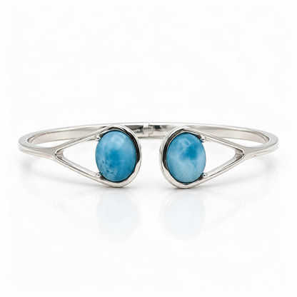 Two-stone Larimar sterling silver bypass cuff bracelet, centered front view on glossy white